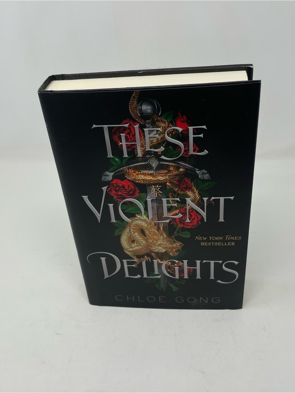 Source Unknown Black Hardcover Book with Red and Gold Accents